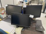 two computer monitors sitting on a desk next to each other
