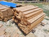 many pieces of wood that are stacked up on the ground