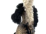 helmet with feathers on it and a feathered hat on top of it