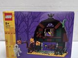 the box is open to show the contents of the lego haunted house