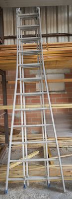 many ladders that are stacked up in a room