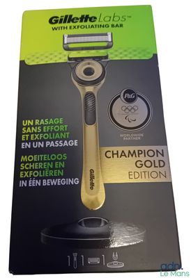 the packaging of a razor with a gold handle is shown