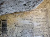 a close up of a label on a piece of wood