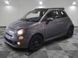 a picture of a small grey car parked in a garage