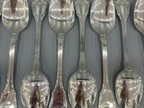 many spoons that are lined up together on the table