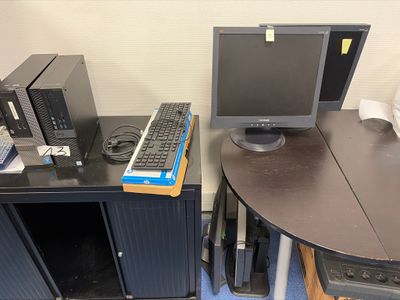 a computer desk with a monitor and keyboard on it