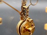 a close up of a clock with a chain attached to it