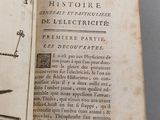 an open book with a drawing of a machine on it
