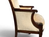 an image of a wooden chair with a beige upholstered seat