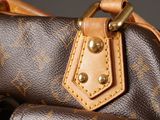 a brown and tan bag with a brown handle