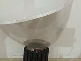 a lamp that is sitting on a table next to a wall