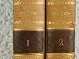 the two books are sitting side by side on the table