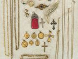 many different types of necklaces and rings on the table