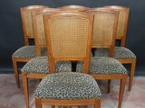 four chairs with leopard print upholstered seats in a room
