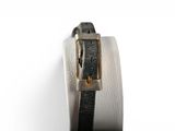 a close up of a black and white watch on a white surface
