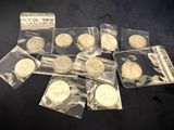 several coins are in a bag on a black surface