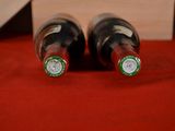 two bottles of wine that are sitting on a table