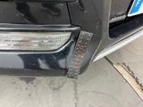 a close up of a car ' s front bumper with a sticker on it