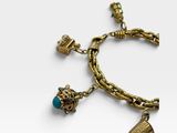 a close up of a gold bracelet with charms on it
