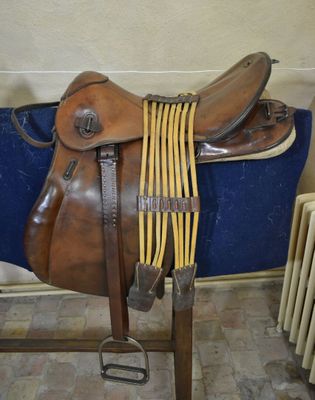 a saddle that is sitting on a stand in a room
