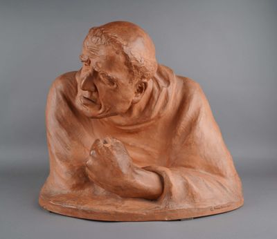 a statue of an old man holding his hands together