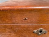 a small wooden box with a key on it