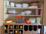 a kitchen with a sink and a cabinet with dishes on it