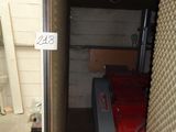 a small room that has a red lawn mower in it