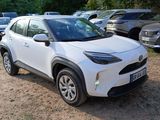 the white toyota c - hr is parked in a lot with other cars