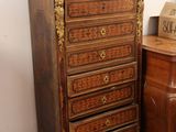a small chest of drawers next to a small table