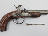 an old gun with a wooden handle and a metal handle