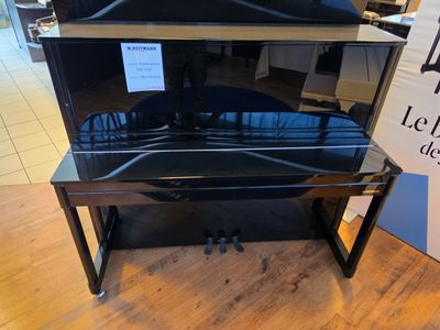 a black piano that is on display in a store