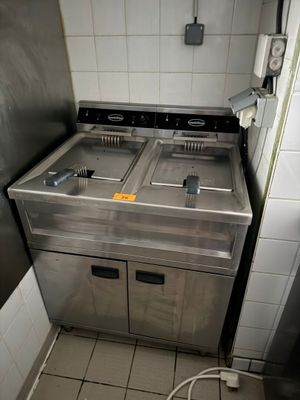a kitchen with two sinks and a refrigerator in it