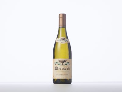 a bottle of white wine sitting on top of a table