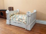 a small dog bed in the corner of a room