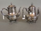 pair of silver plated teapots on stand with tags