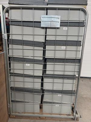 a metal rack with several bins on top of it