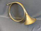 an old brass trumpet on a blue cloth with a white background