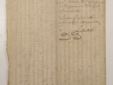 an old piece of paper with writing on it sitting on a table