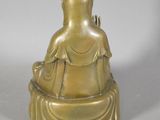 bronze statue of a person sitting in a meditation position