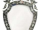 silver plated mirror with ornate design on a white background