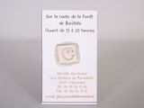 a small business card with a smiley face on it