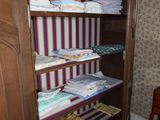 a closet with a chair and a table in front of it