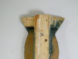 a wooden object that is hanging on the wall