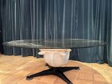 a round table with a glass top on a wooden floor