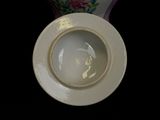 a close up of a white porcelain bowl with a lid