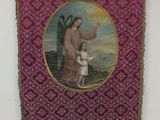 a red and gold tapestry with a painting of a man holding a child