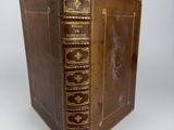 an old brown book with gold trim and gold trim on the cover