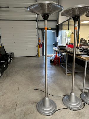 two metal lamps that are on the floor in the room