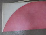 a pink and white piece of paper on a table